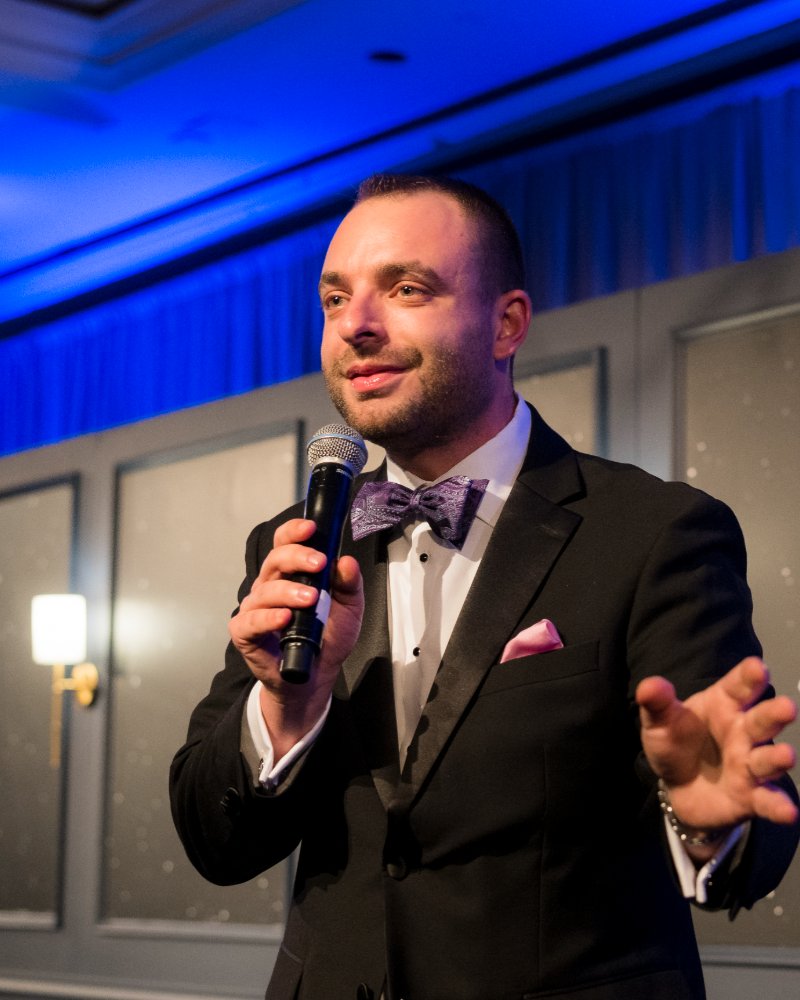 Max Wolf hosting a benefit auction
